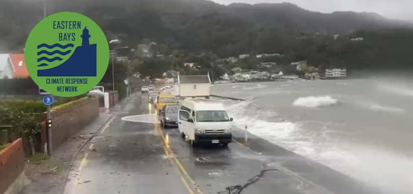 Sea breaking over road with logo